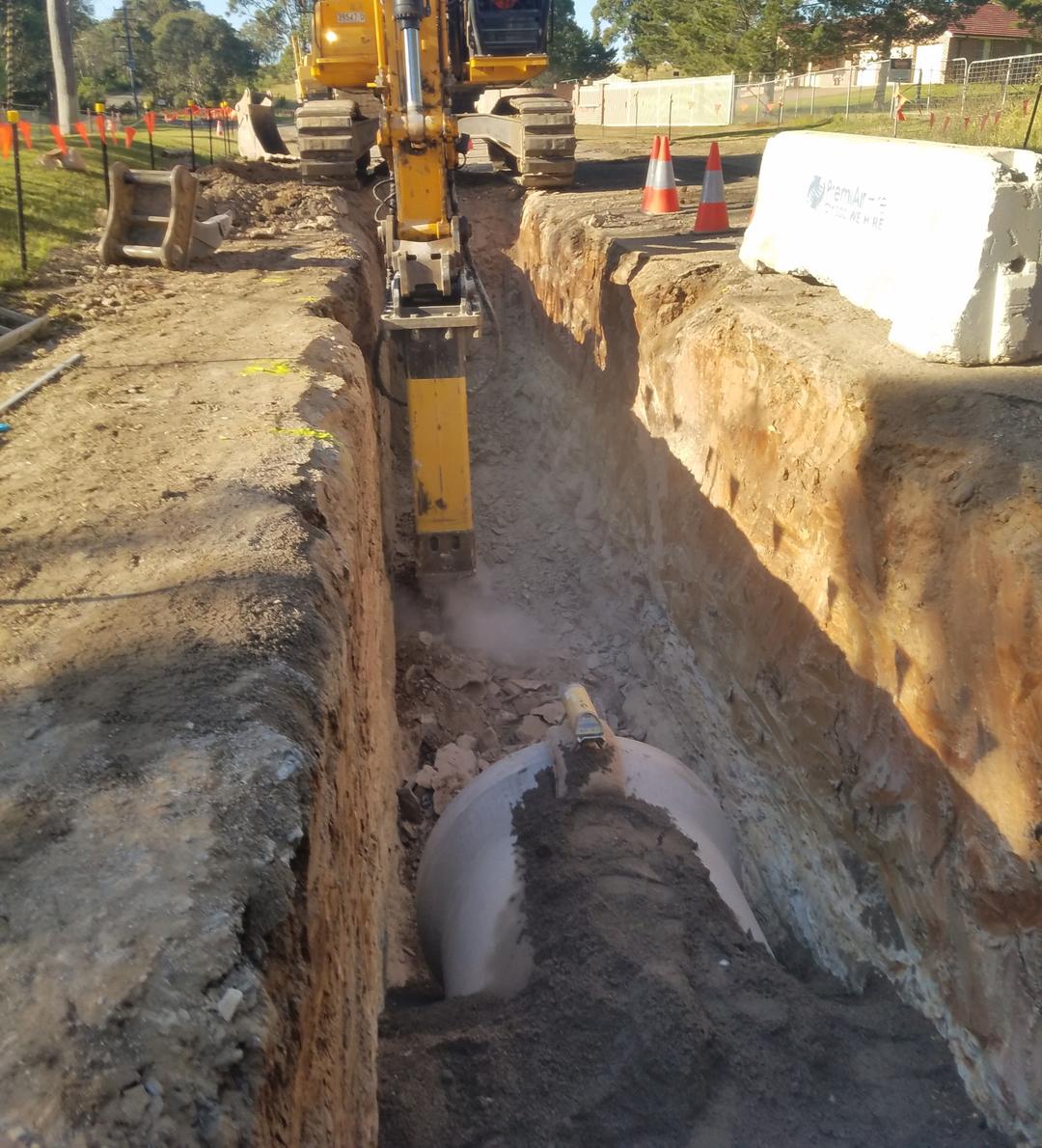 High-contrast photo of heavy industrial pipes and machinery at a complex construction site in Mount Maunganui